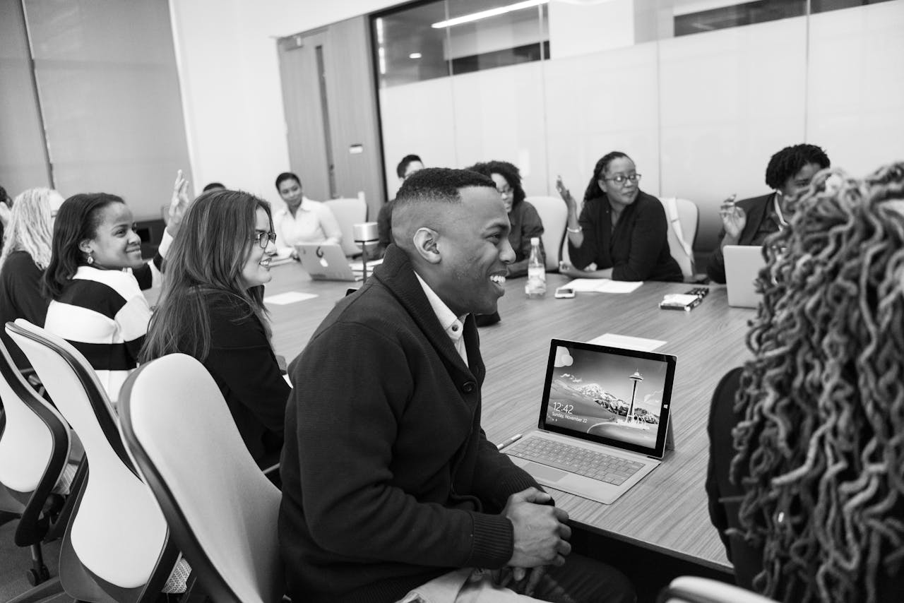 ROSARIUM CONSULTING Business professionals engaged in a collaborative meeting in a modern office setting.